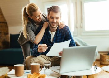 happy couple analyzing their home budget while paying bill computer scaled