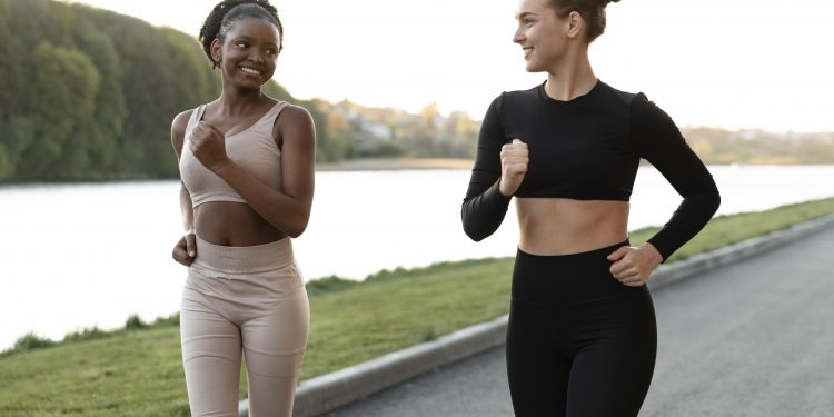 women doing fitness outdoors together scaled