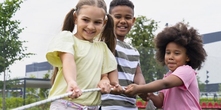 kids playing with rope medium shot scaled