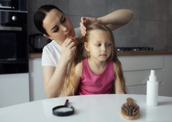 mother taking care child with head lices scaled