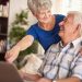 Um casal de idosos olhando o computador